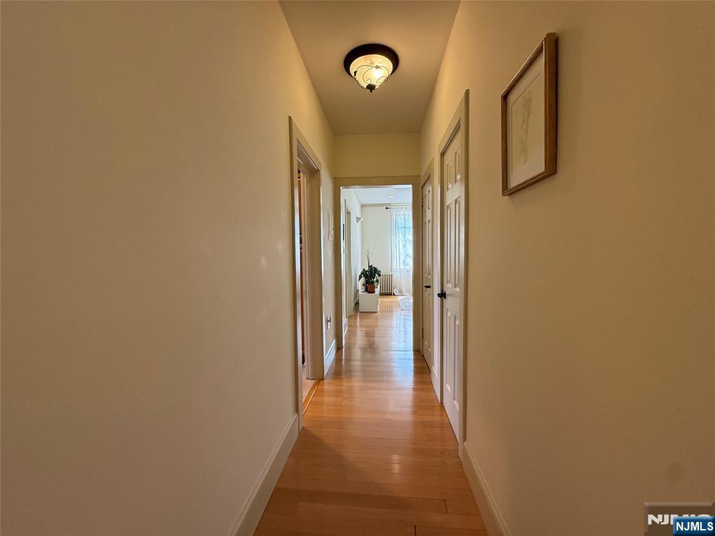 215 Orient Way, Unit C2 Rutherford, NJ 07070 - Photo 20 of 25 a view of a hallway with wooden floor and door