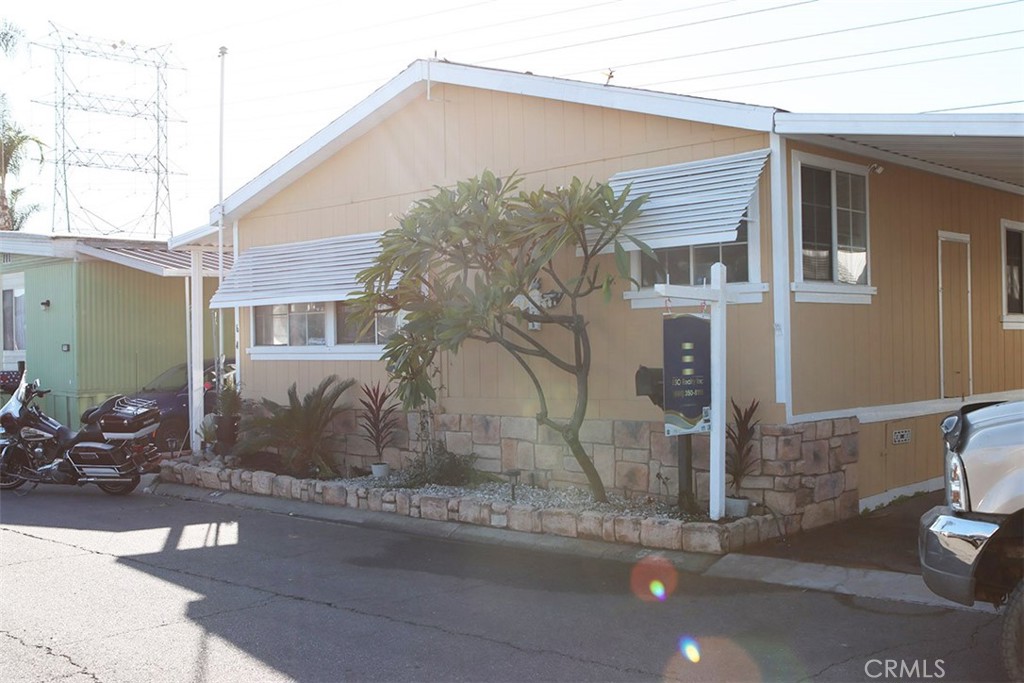 10001 West Frontage Road, Unit 64 South Gate, CA 90280 - Photo 25 of 35 a front view of a house with a yard