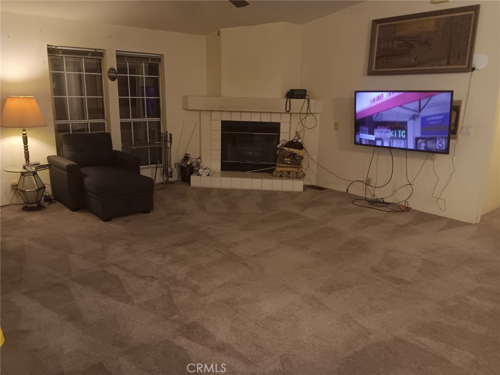 10001 West Frontage Road, Unit 64 South Gate, CA 90280 - Photo 3 of 35 a living room with furniture a front door and a fireplace