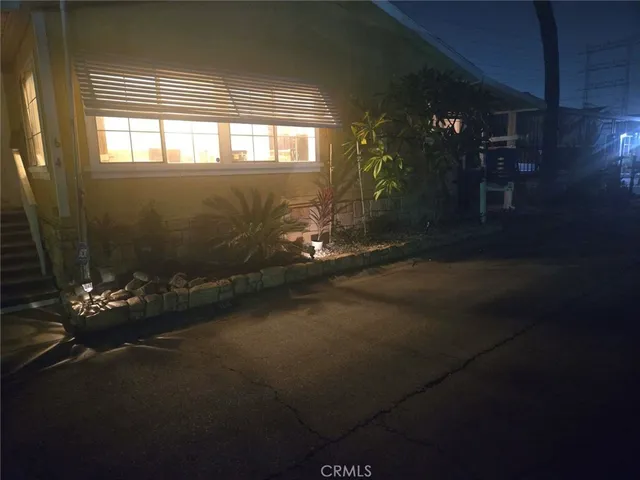 a living room with hard wood flooring and a fireplace