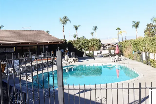 a view of a house with swimming pool and sitting area