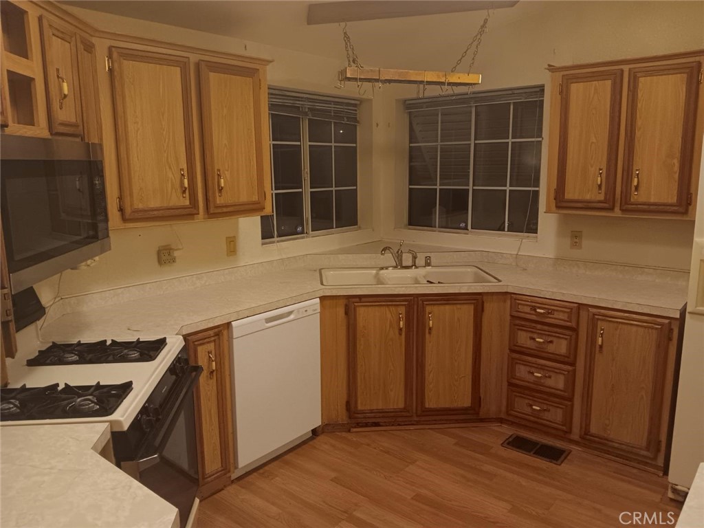 10001 West Frontage Road, Unit 64 South Gate, CA 90280 - Photo 5 of 35 a kitchen with stainless steel appliances granite countertop a stove a sink and a microwave