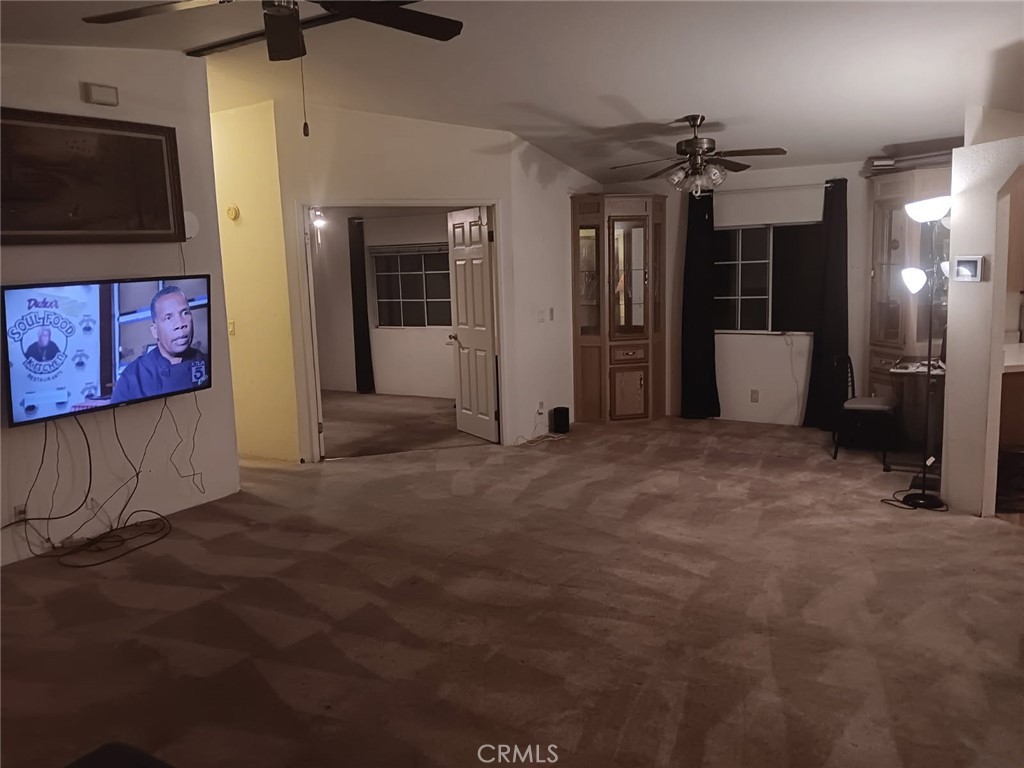 10001 West Frontage Road, Unit 64 South Gate, CA 90280 - Photo 6 of 35 a view of a hallway with a refrigerator and microwave