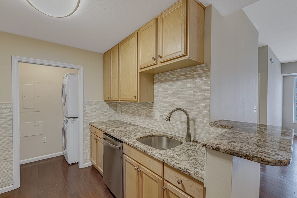 38 Village Road, Unit 305 Middleton, MA 01949 - Photo 4 of 25 a kitchen with granite countertop a sink and a stove