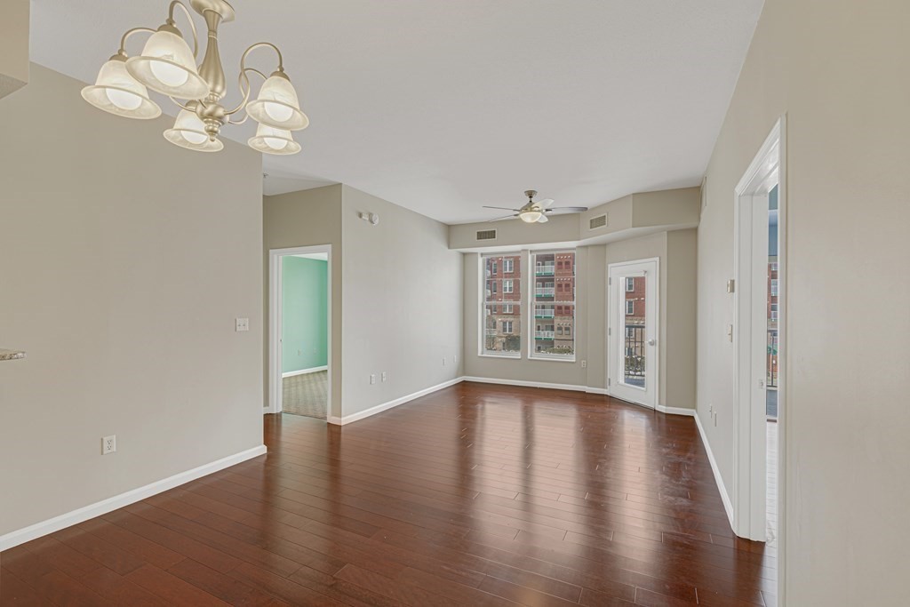 38 Village Road, Unit 305 Middleton, MA 01949 - Photo 8 of 25 a view of an empty room with wooden floor and a window