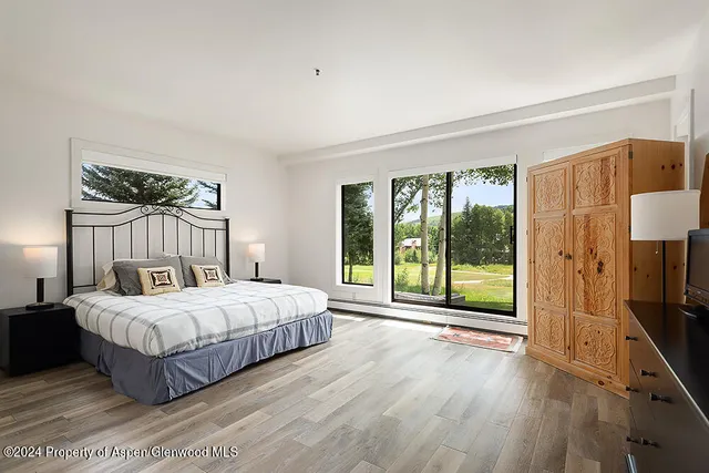 a bedroom with a large bed and a large window