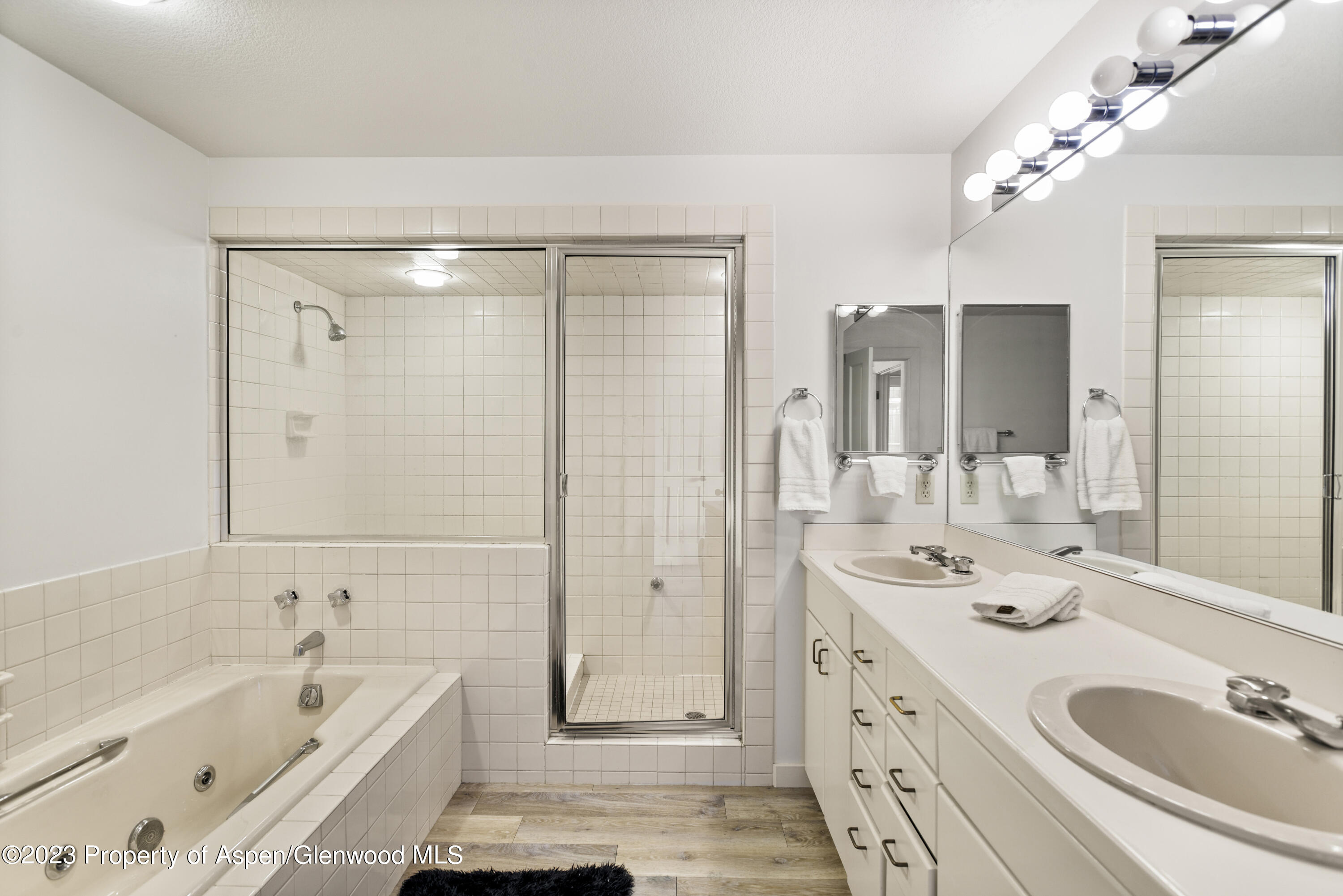 3904 Brush Creek Road, Unit 11 Snowmass Village, CO 81615 - Photo 15 of 25 a bathroom with a tub a sink double vanity and mirrors