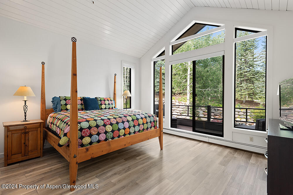 3904 Brush Creek Road, Unit 11 Snowmass Village, CO 81615 - Photo 16 of 25 a bedroom with a large bed and a large window