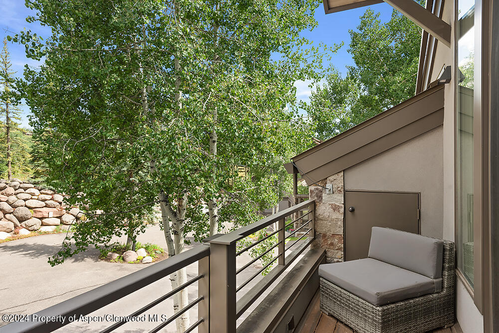3904 Brush Creek Road, Unit 11 Snowmass Village, CO 81615 - Photo 18 of 25 a balcony with wooden floor and outdoor seating