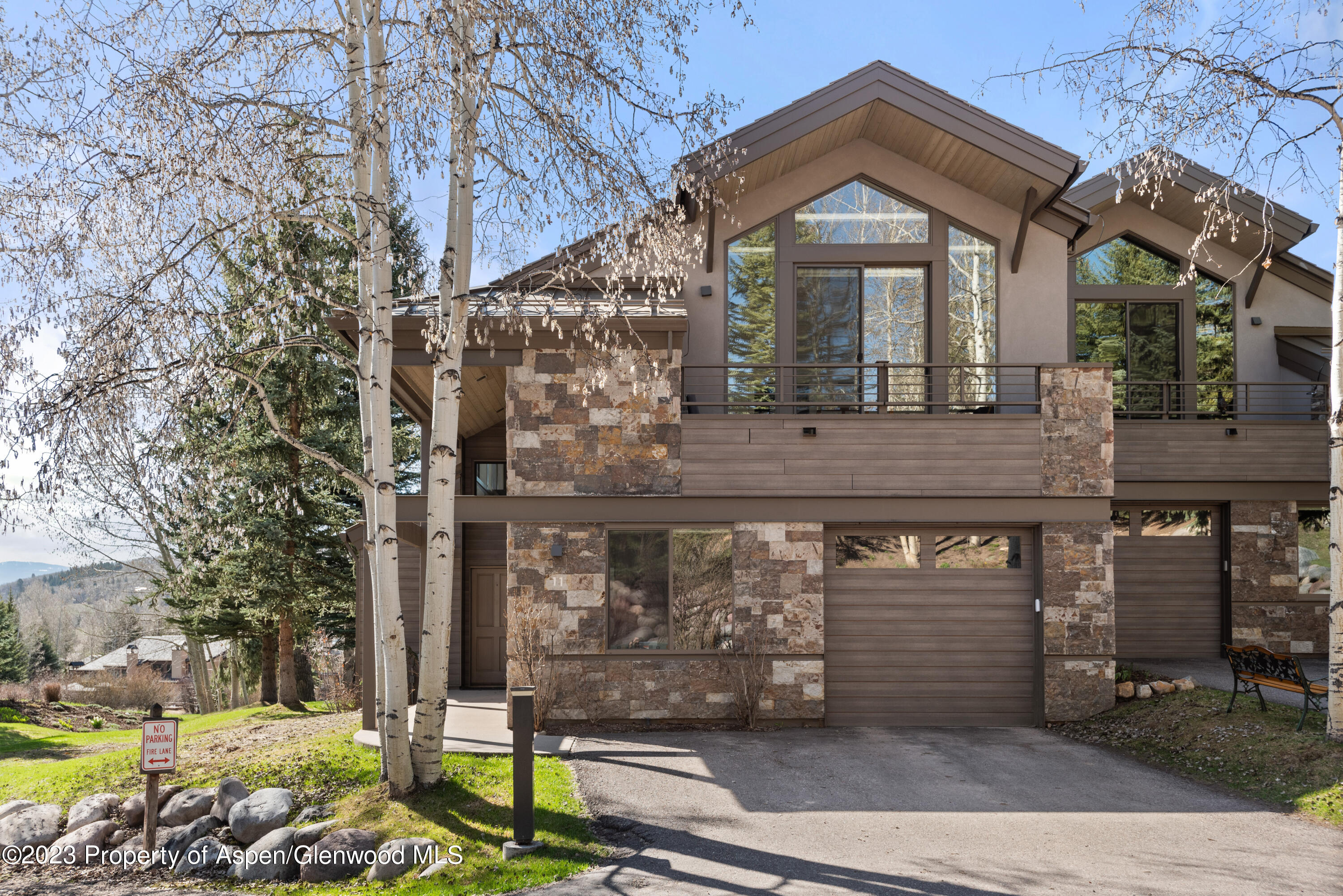 3904 Brush Creek Road, Unit 11 Snowmass Village, CO 81615 - Photo 2 of 25 a front view of a house with garden