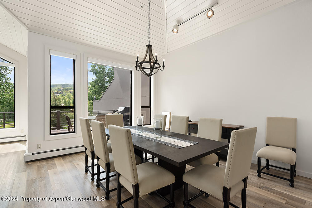 3904 Brush Creek Road, Unit 11 Snowmass Village, CO 81615 - Photo 9 of 25 a view of a dining room with furniture window and wooden floor