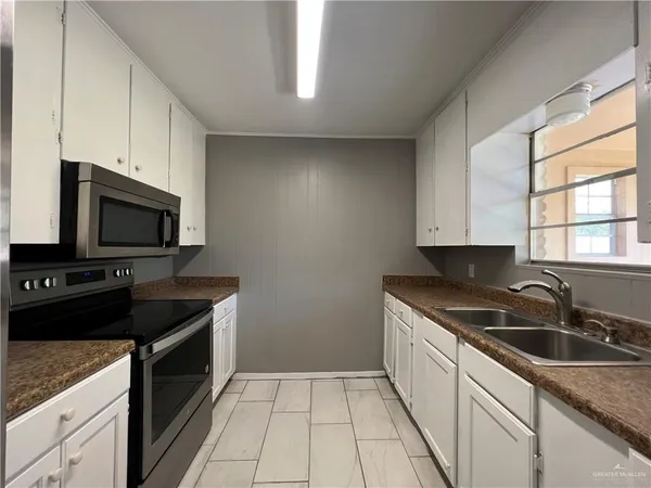 a kitchen with a sink and cabinets