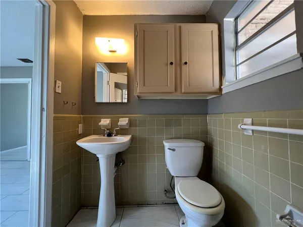 an empty room with closet and windows