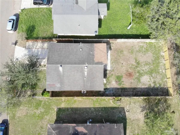 an aerial view of a house with a yard