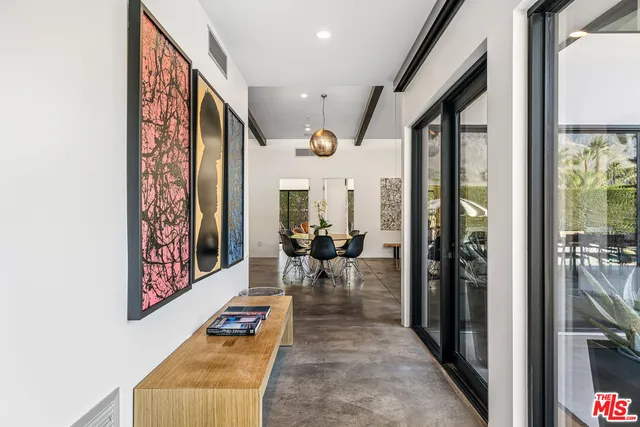 a living room with furniture a rug and a window