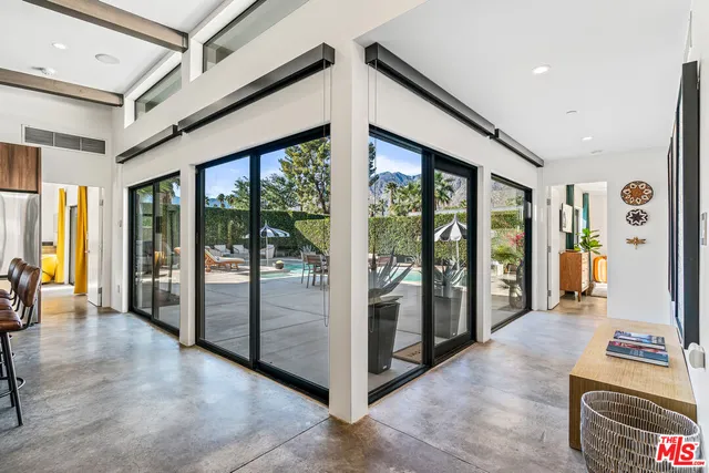 a kitchen with kitchen island a dining table and chairs