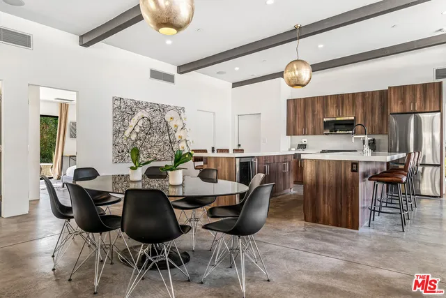 a kitchen with kitchen island granite countertop a stove a sink and a refrigerator