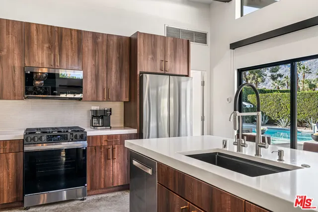 a bathroom with a sink a large mirror and shower