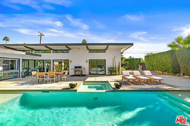a view of swimming pool with outdoor seating