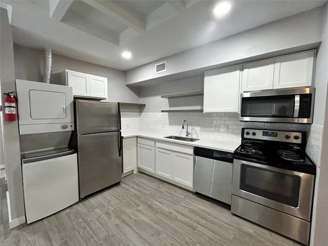 a kitchen with a refrigerator stove and microwave