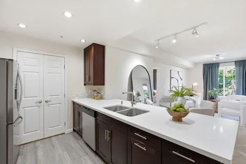 a kitchen with stainless steel appliances sink stove microwave and cabinets