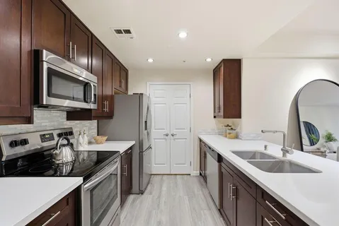 a bathroom with a sink double vanity and a mirror