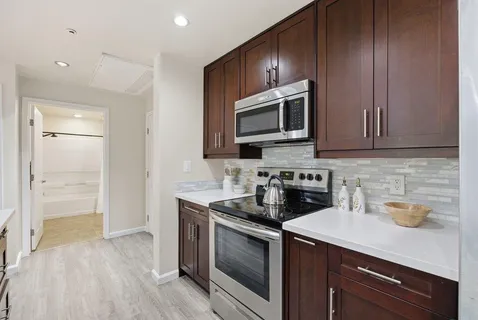 a kitchen with a refrigerator and a sink