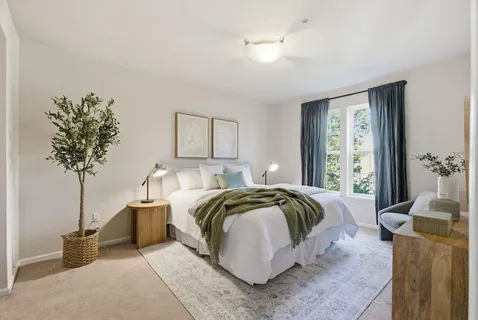 a bedroom with a bed and chandelier