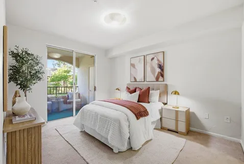 a bedroom with a bed and a potted plant