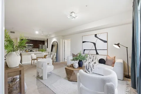 a living room with furniture a fireplace and kitchen view