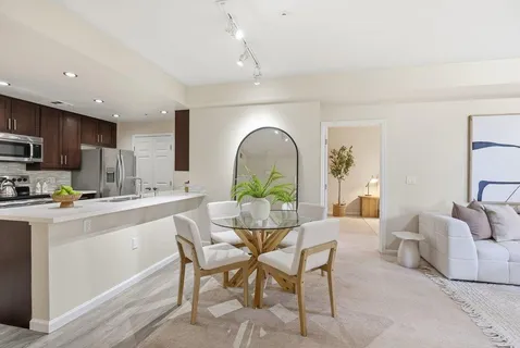 a kitchen with appliances a counter space and a dining room
