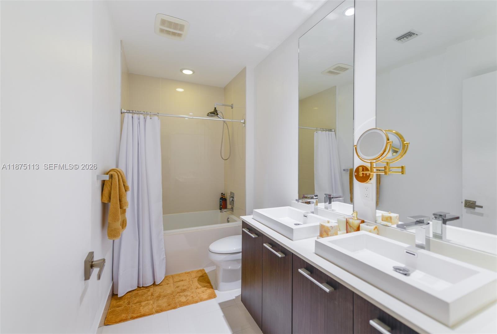 45 Southwest 9th Street, Unit 4108 Miami, FL 33130 - Photo 11 of 28 a bathroom with a sink and a mirror