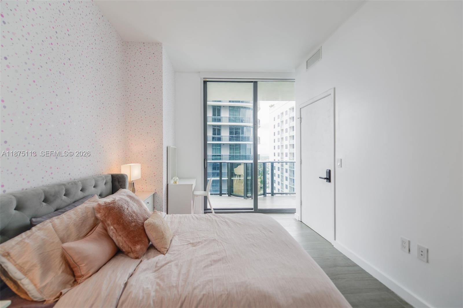 45 Southwest 9th Street, Unit 4108 Miami, FL 33130 - Photo 13 of 28 a bedroom with a bed and a window