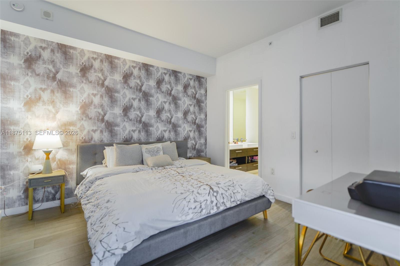 45 Southwest 9th Street, Unit 4108 Miami, FL 33130 - Photo 17 of 28 a bedroom with a bed and a lamp on dresser