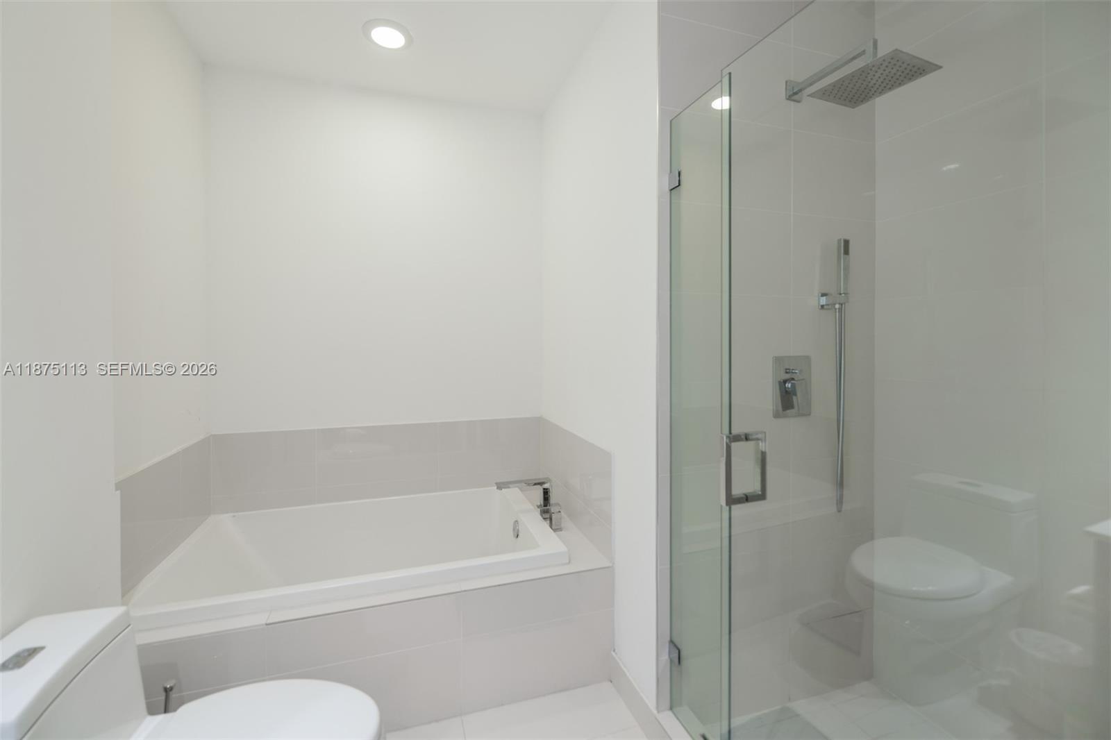 45 Southwest 9th Street, Unit 4108 Miami, FL 33130 - Photo 20 of 28 a white bath tub sitting next to a toilet