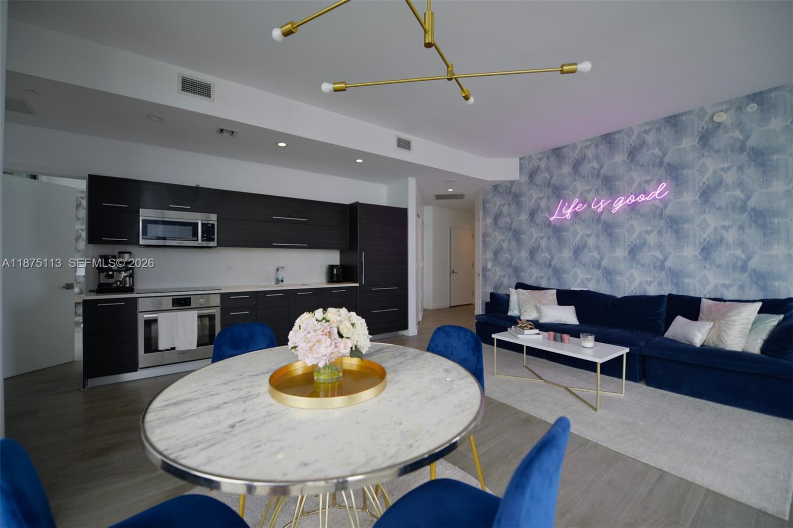 45 Southwest 9th Street, Unit 4108 Miami, FL 33130 - Photo 5 of 28 a living room with furniture and kitchen view