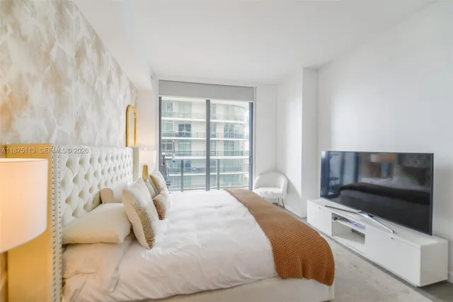 a bedroom with a bed and a television