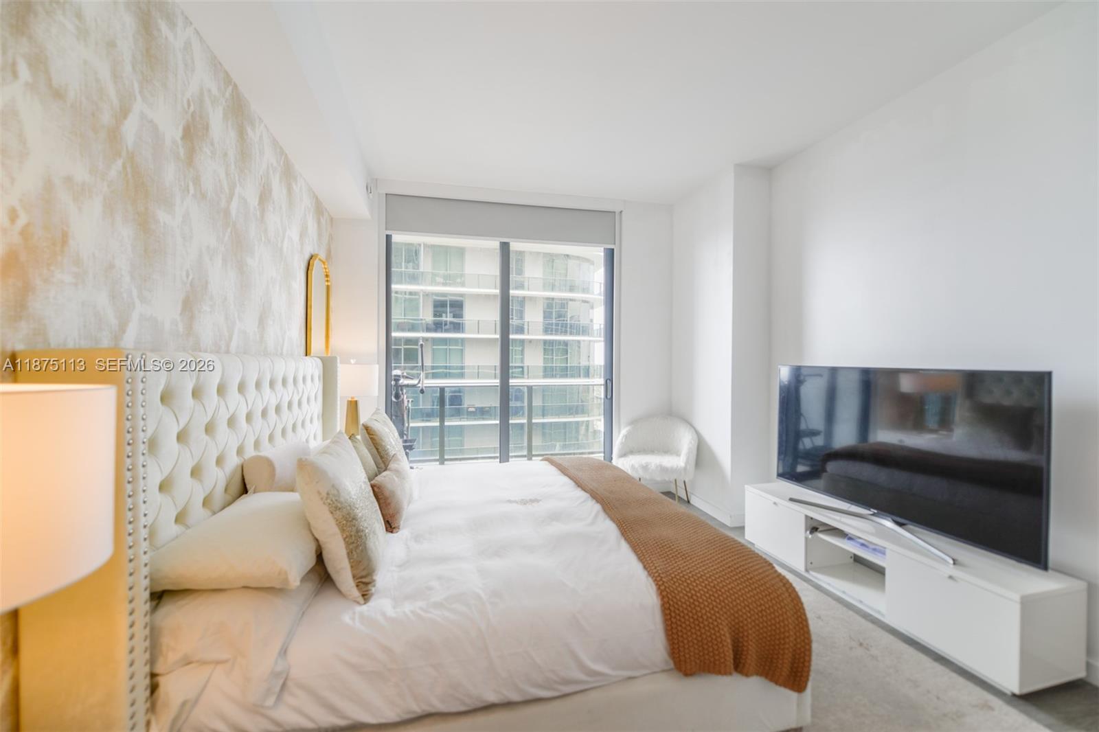 45 Southwest 9th Street, Unit 4108 Miami, FL 33130 - Photo 10 of 28 a bedroom with a bed and a television