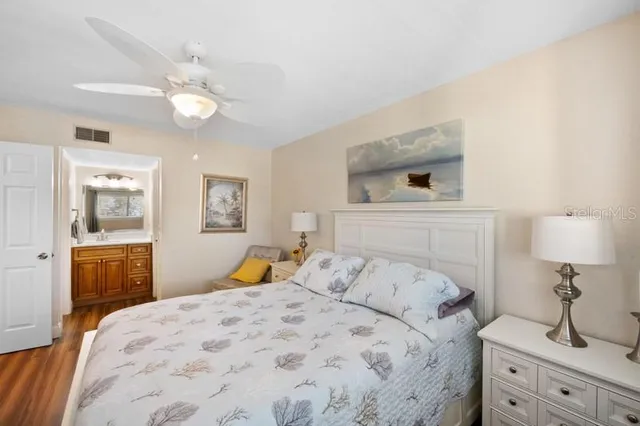 a bedroom with a large bed and a chandelier