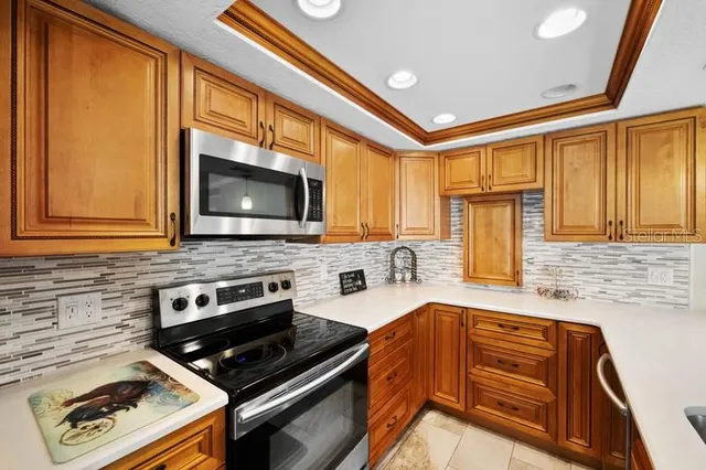 a kitchen with stainless steel appliances granite countertop a stove and a microwave