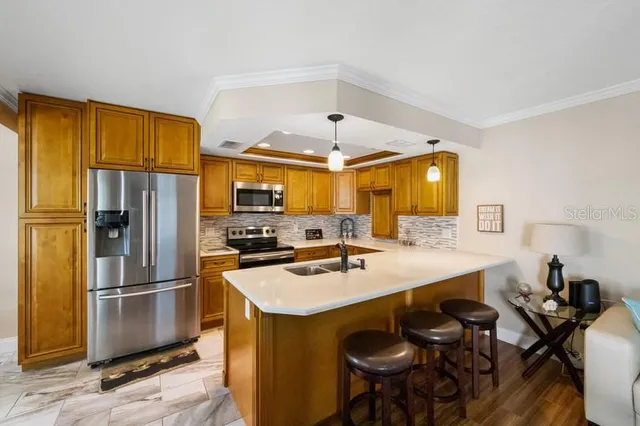 a kitchen with a sink appliances and cabinets