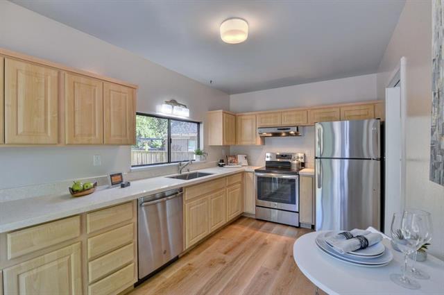 4 Farm Road Los Altos, CA 94024 - Photo 6 of 25 a kitchen with stainless steel appliances kitchen island granite countertop a sink dishwasher stove and refrigerator with wooden floor
