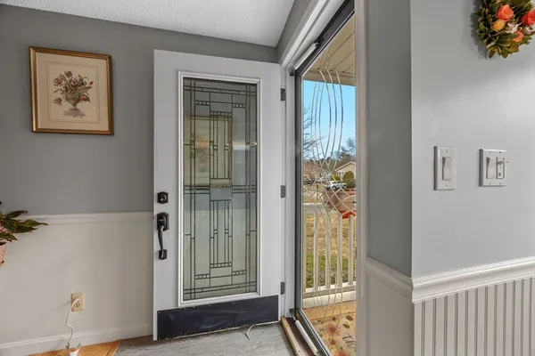 a view of a hallway with wooden floor and closet