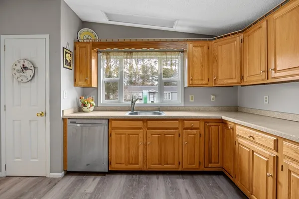 a kitchen with stainless steel appliances granite countertop a sink and cabinets