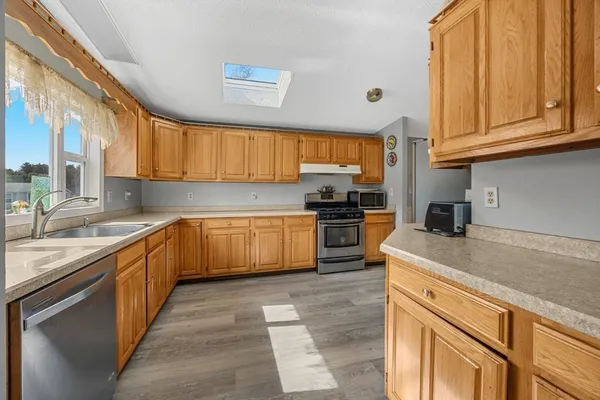 a kitchen with stainless steel appliances granite countertop a sink and cabinets