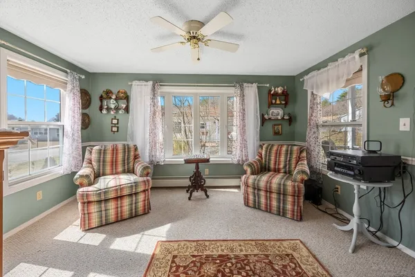 a living room with furniture and large windows