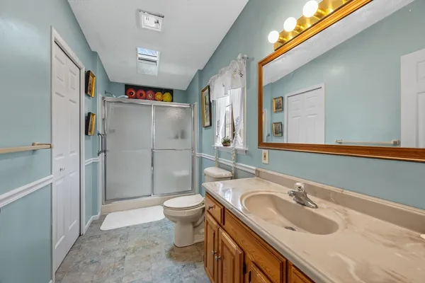 a bathroom with a sink toilet and shower