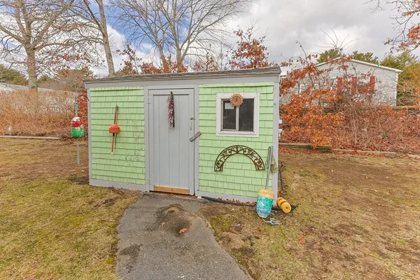 a view of a house with a backyard and garage