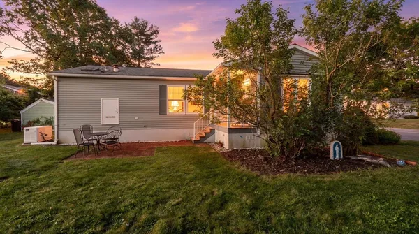 a backyard of a house with table and chairs