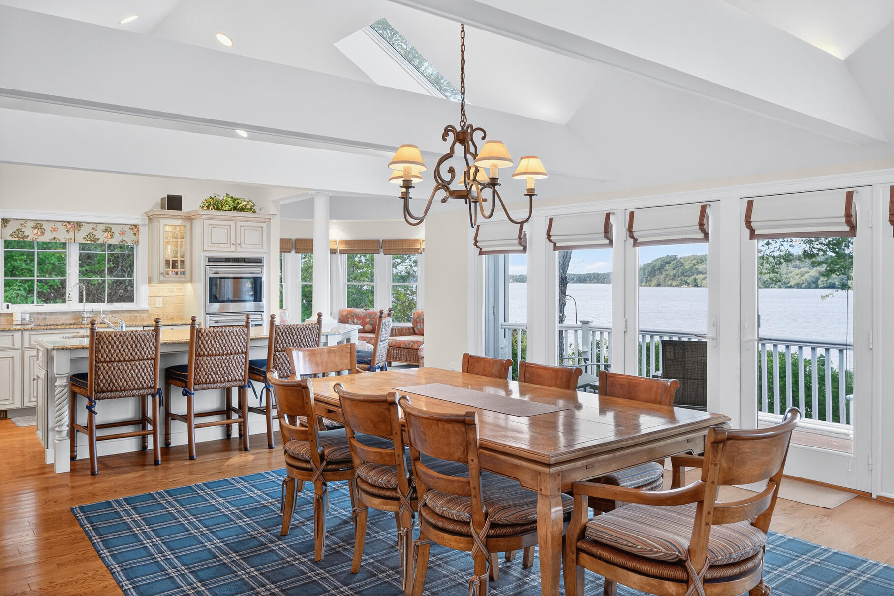 10 Brian Way Harwich, MA 02645 - Photo 14 of 75 a dining room with wooden floor a chandelier a wooden table and chairs